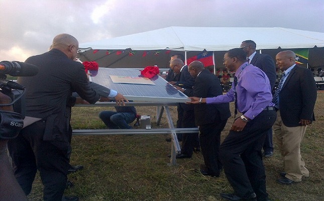 Officials symbolically laying the first panel for the Solar Farm at the Robert L. Bradshaw International Airport (Photos by Erasmus Williams)